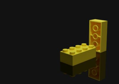 To gule LEGO-brikker (2x4) i en spændende komposition med belysning og refleksion.